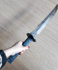 Hand holding a Full Tang Carbon Steel Machete Sword With Leather Sheath For Practice And Outdoor Use Twenty Point Five Inch Blade