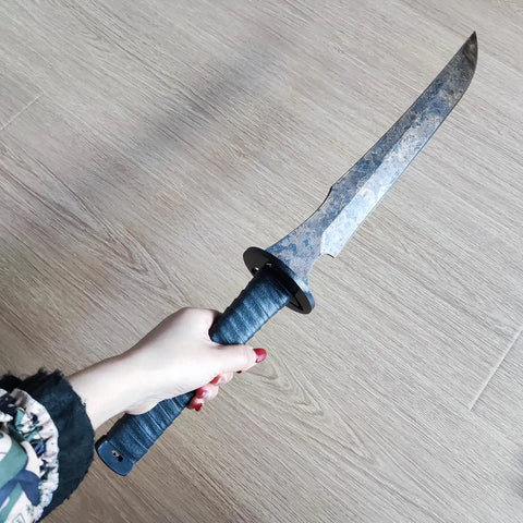 Hand holding a Full Tang Carbon Steel Machete Sword With Leather Sheath For Practice And Outdoor Use Twenty Point Five Inch Blade