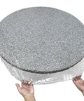 Hands fitting Crystal Clear Vinyl Round Tablecloth With Elastic Edge Fits 27 To 31 Inch Tables Spill Proof Waterproof Cover