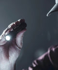 Hand holding MacroStream USB Rechargeable EDC Flashlight With 500 Lumens And 2000 Candela Compact Pocketable LED Light in a dim setting