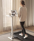Total Game Changer Over Bed Table With Smooth Rolling Casters And No Sweat Pneumatic Height Adjustment Super Spacious Work Surface for standing use near window.