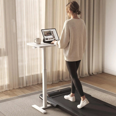 Total Game Changer Over Bed Table With Smooth Rolling Casters And No Sweat Pneumatic Height Adjustment Super Spacious Work Surface for standing use near window.