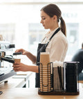 Barista using Three Compartment Coffee Cup And Lid Holder With Wooden Base, Go To Countertop Coffee Station Organizer