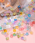 Acrylic Frosted Flower Beads Six Millimeter With Golden Speckles in storage box for jewelry making projects.