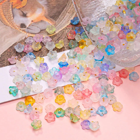 Acrylic Frosted Flower Beads Six Millimeter With Golden Speckles in storage box for jewelry making projects.