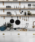 Modern kitchen counter with cooking utensils, glassware, and small appliances, highlighting an organized and stylish workspace.