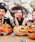 Family celebrating Halloween with pumpkin carvings and 140 Piece Play Money Set For Kids With 7 Denominations.
