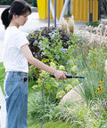 Electric Plant Sprayer Battery Powered Wand in use for garden watering with telescopic reach, focusing on handheld design.