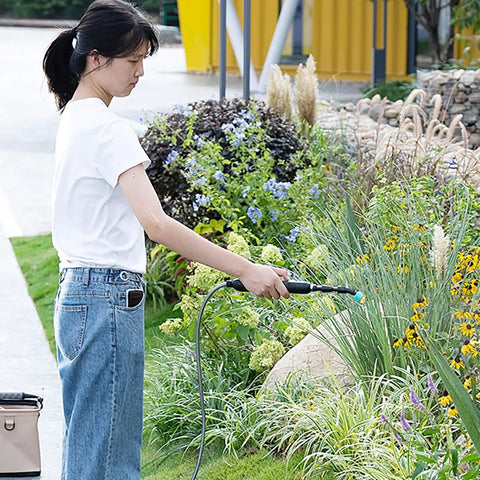 Electric Plant Sprayer Battery Powered Wand in use for garden watering with telescopic reach, focusing on handheld design.