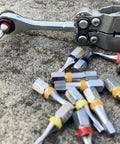 Go To One Quarter Inch Hex End EDC Ratchet Wrench For Multitools With Hex Bit Adapters Stainless Steel Build on stone surface