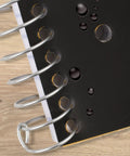Hustle Ready Black Spiral Notebook With Five Subject Sections And College Ruled Paper providing clean lines, showing water-resistant cover detail.
