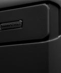 Traveler's Choice hardside luggage close-up of black textured shell with logo plate