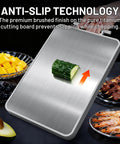 Two In One Titanium And Ebony Wood Cutting Board With Handle And Juice Groove, double sided with cucumber on titanium surface