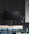6 Pack Acoustic Wall Panels 47.2 By 23.6 Inches Black Sound Proof Panels on textured wall behind TV in modern decor.