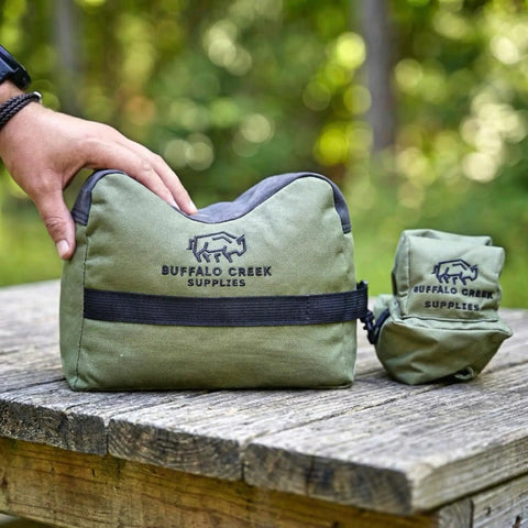 All Weather Front And Rear Shooting Bag Combo For Target Practice And Bench Rest Use Durable Olive Drab Bags For Hunting AR-15 AR-10 Shotgun And Pistol Unfilled And Ready To Fill on wooden table