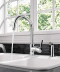 Precept Single-Handle Kitchen Faucet With Side Sprayer In Chrome, 360 Degree Swivel, installed on a dual basin kitchen sink.