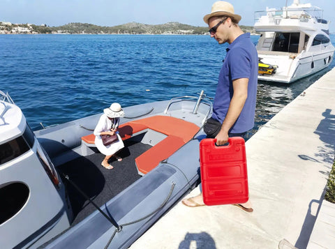 Person carrying Portable 6 Gallon 24L Marine Fuel Tank With 9.8 Foot Hose Level Gauge And L Shaped Handle on a boat dock