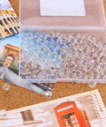Heavy Duty Gold Push Pins With Crisp Clear Round Heads Top Shelf Office Gear For Maps Bulletin Boards And Cork Walls 100 Count in a clear storage box.