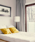 Lucas LED Floor Lamp With Drum Shade And Warm Wood Finish beside bed in modern bedroom with yellow cushions.