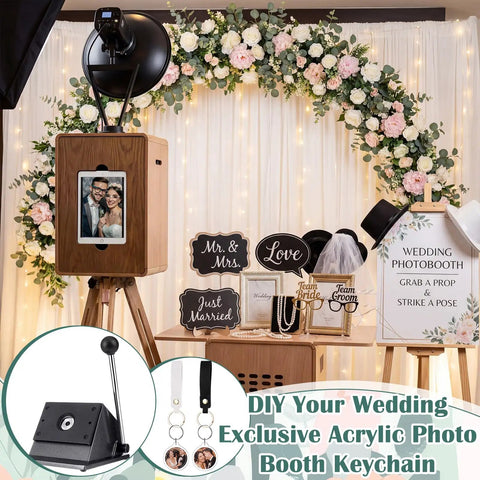 DIY Button Keychain Photo Cutter Kit With 61 Pieces Including 1 Inch Button Cutter 25mm 30 Double Sided Acrylic Frame Keychains And 30 PU Leather Keychains In Black And White Great For Photo Booth Props And Party Favors, displayed at a wedding photobooth setup with floral decorations.