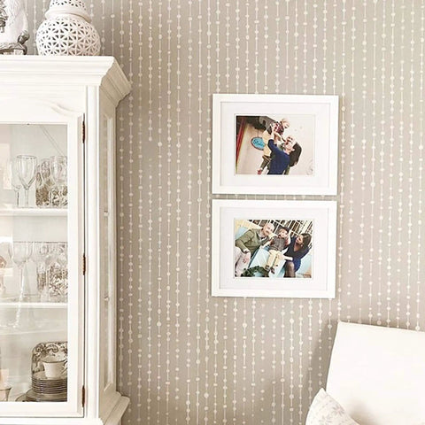 Dew Drops XL Wall Stencil 24 X 39.5 In For Large Geometric Wall Patterns in living room with framed pictures and cabinet