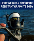 Angler holding Wrath II Saltwater Spinning Reel 3000 Size with corrosion-resistant graphite body by water.