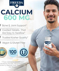 Smiling man holding bottle of Calcium 600 Mg Supplement For Strong Bones Joints And Teeth Supports Healthy Muscle And Nerve Function Easy To Swallow Coated Tablets Gluten Free 100 Count.