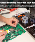 Person using No Clean Soldering Flux 558 10cc 10mL Rosin Paste For Electronics With Needle Dispensing Tool on circuit board.