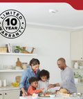 Top Shelf Smoke Detector With Ten Year Sealed Battery And Eighty Five Decibel Alarm Featuring Bright Led Status Indicator For Fo Sho Home Security And Swift Fire Alert Response mounted in a bright kitchen with family cooking.