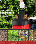Person using functional push paddle on Powerful 15 Amp Corded Wood Chipper Shredder With 15 To 1 Reduction for yard debris