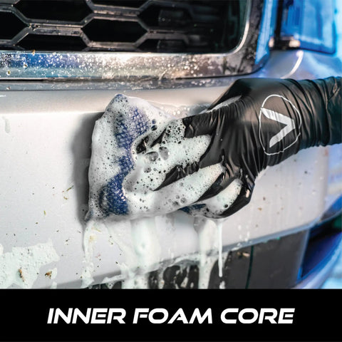 Mesh Bug Scrub Sponge For Cars 4x6 Inch, Tar And Bug Remover, in use on vehicle bumper, showing inner foam core, safe on paint.
