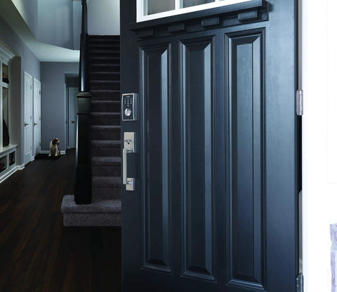 Century Front Entry Handleset With Latitude Lever Satin Nickel Finish installed on a black door, modern interior in background