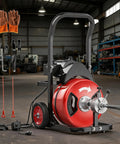 Heavy Duty Electric Drain Snake With 100 Foot Steel Core Cable And Four Precision Cutters, shown with accessories and tools.