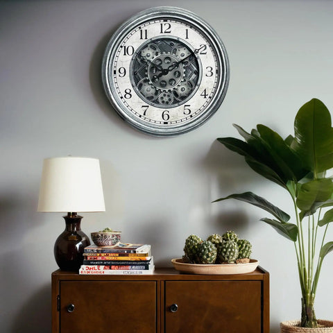 Large 15 Inch Moving Gears Wall Clock In Sleek Silver, Industrial Steampunk Vintage Decor With Bold Numbers on a wall.