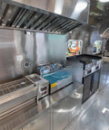Fully Equipped Compact Concession Food Trailer Mobile Kitchen For Street Vending interior with stainless steel workspace and appliances.
