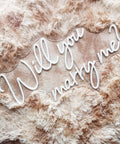 Will You Marry Me Neon Sign For Proposals And Weddings, 25 By 15 Inches, Warm White LED Lights on soft textured backdrop
