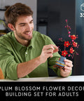 Botanicals Plum Blossom Building Set For Adults Diy Flower Craft Kit For Dining Table Centerpiece And Living Room Decor Grown Folks Friendly 18 Plus Relaxing Creative Experience Gift For Birthdays 10369, man assembling 327-piece plum blossom display