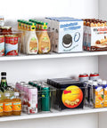 Bulk Clear Storage Bins Set Of 12 With Durable Handles And Blank Labels For Stackable Plastic Pantry Organization across various food items on shelves.