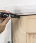 EasyScribe Scribing Tool for Accurate Layouts Across Carpentry, Joinery, Tiling, Kitchen Fitters, and Shop Fitters with a Pro Grade Adjustable Offset Arm From 0.04 to 1.57 Inches, Black being used on a door frame for precise marking.
