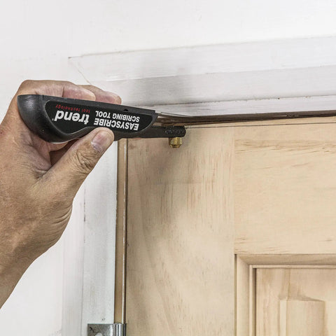EasyScribe Scribing Tool for Accurate Layouts Across Carpentry, Joinery, Tiling, Kitchen Fitters, and Shop Fitters with a Pro Grade Adjustable Offset Arm From 0.04 to 1.57 Inches, Black being used on a door frame for precise marking.