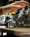 Person using Ken Onion Edition Knife And Tool Sharpening System Mk2 with adjustable angles and blade grinding attachment on workbench