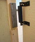 AM3 RM100C Magnet Catch Industrial Type with mounting holes installed on wooden enclosure, powder coated black finish, 100 lb capacity