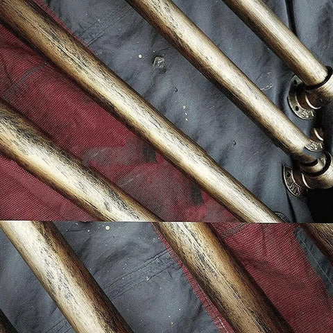 Top Notch Industrial Wrought Iron Pipe Banister Stair Handrail In Antique Brass Finish Featuring Gritty Galvanized Steel Build Built Tough For Indoor Outdoor Hallway And Porch Deck Railing Upgrades close-up of pipes texture on a dark fabric background.