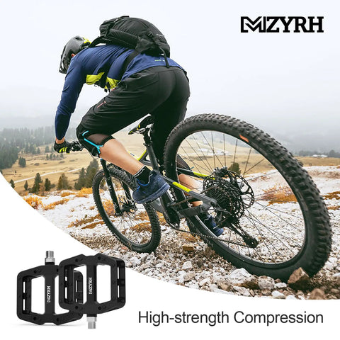 Cyclist riding with Rugged Nylon Fiber Mountain Bike Pedals With Nine Sixteen Inch Spindle, Three Sealed Bearings on trail