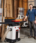 Badass Eight Inch Jointer Featuring Helical Cutterhead And Two Horsepower Motor in a workshop, showing smooth cuts and powerful performance.
