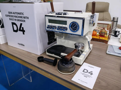 Semi-automatic espresso machine with built-in grinder on a table, next to packaging and manual.