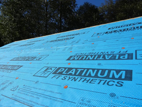 Professional Grade Synthetic Roofing Underlayment Roll, 20 Mil Polyolefin Core laid out on a roof with textured surface.