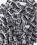 100 Pieces Black Aluminum Pigeon Leg Rings For Bird Identification And Training, 2027 ARPU Serial Number Bands, scattered view.