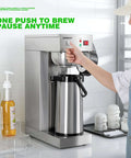 Person operating No-Fuss Auto-Filling Commercial Airpot Coffee Brewer 2.2L 74oz, Stainless Steel Thermal Carafe, in kitchen