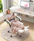 Woman relaxing on Six Point Massage Office Chair With Heat Ergonomic Reclining Desk Chair With Footrest PU Leather Executive Chair For Home Office Off White